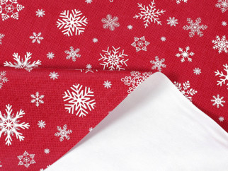 Textil hátoldalú pvc terítő - Karácsonyi mintás, hópihék piros alapon - méteráru 140 cm széles