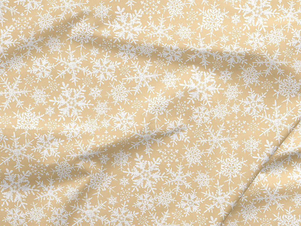 Pamutszövet - karácsonyi mintás, hópihék aranyszínű alapon